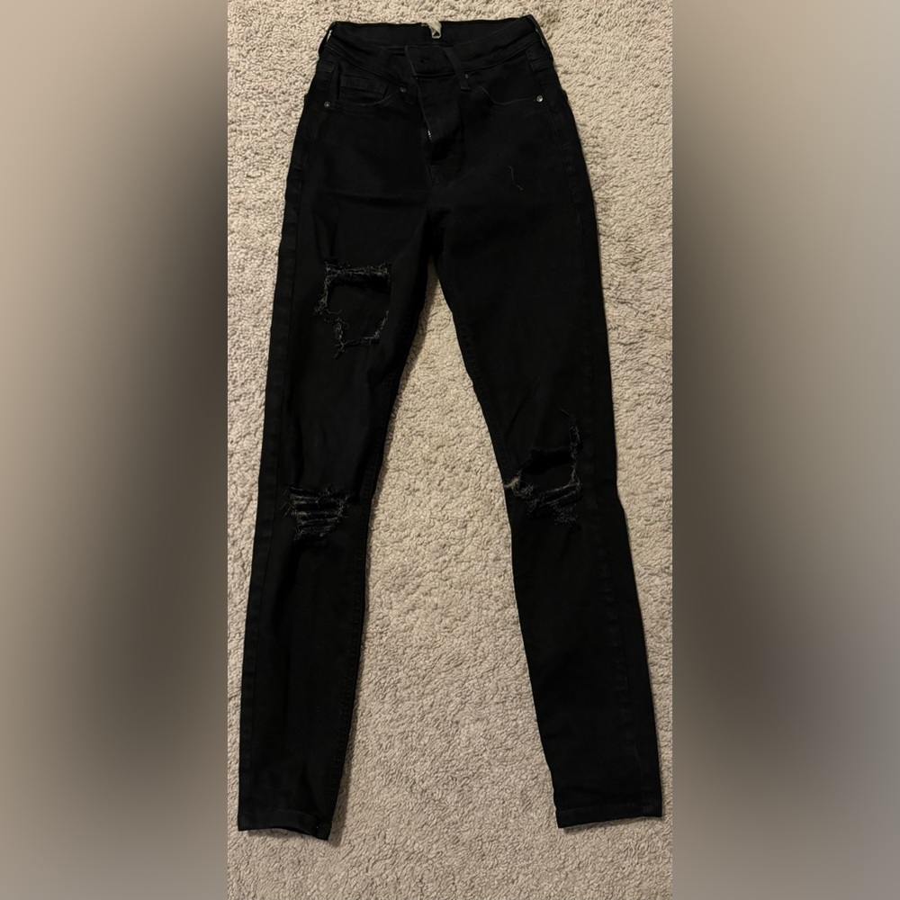 Black ripped Topshop skinny jeans, size 25.